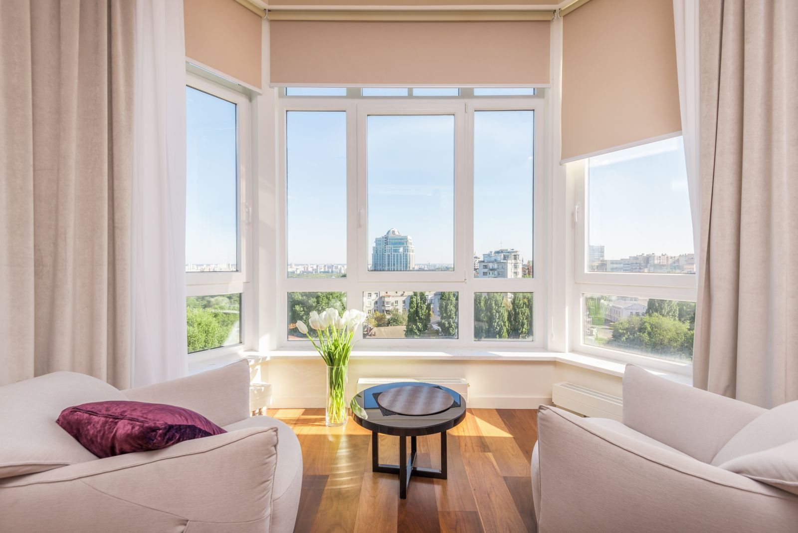 Open furnished living and dining space with floor-to-ceiling windows